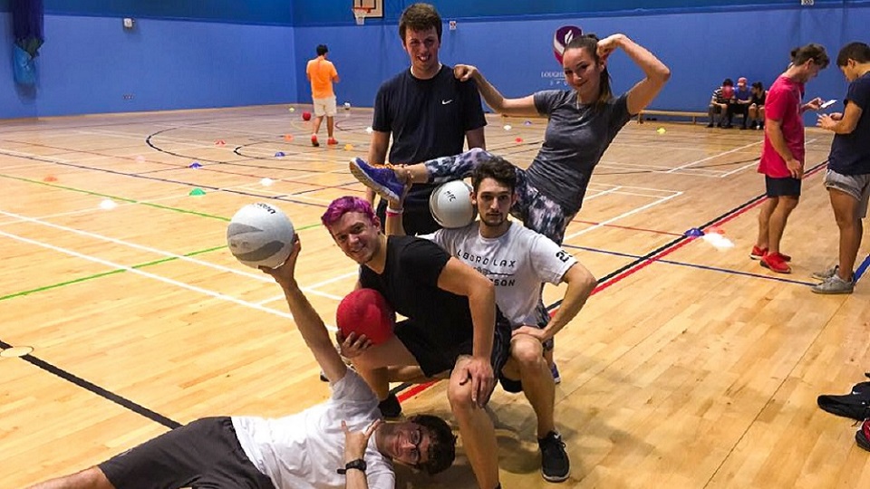 Anastasia and four friends posing for a photo at a dodgeball session in Holywell Sports hall. 