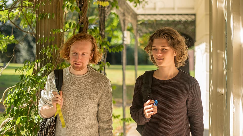 Two students walking through campus.