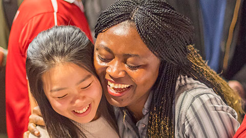 Two female students hugging