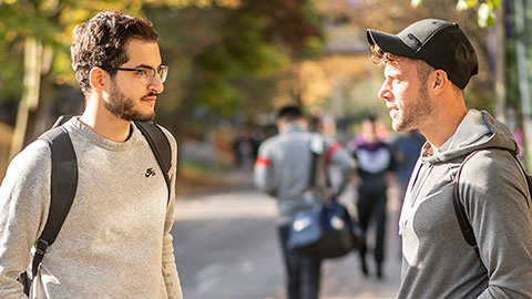 Two male students talking outside