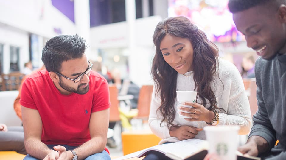 Students sat at a table in the Students' Union
