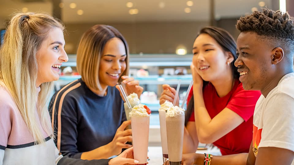 friends laughing with milkshake