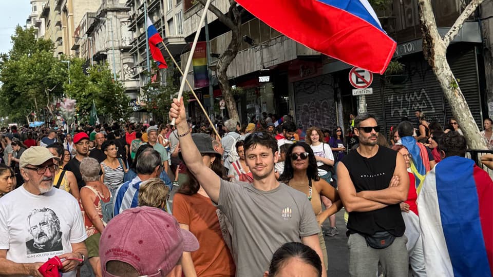 Student Luke Lewis waving a flag amongst a street party.
