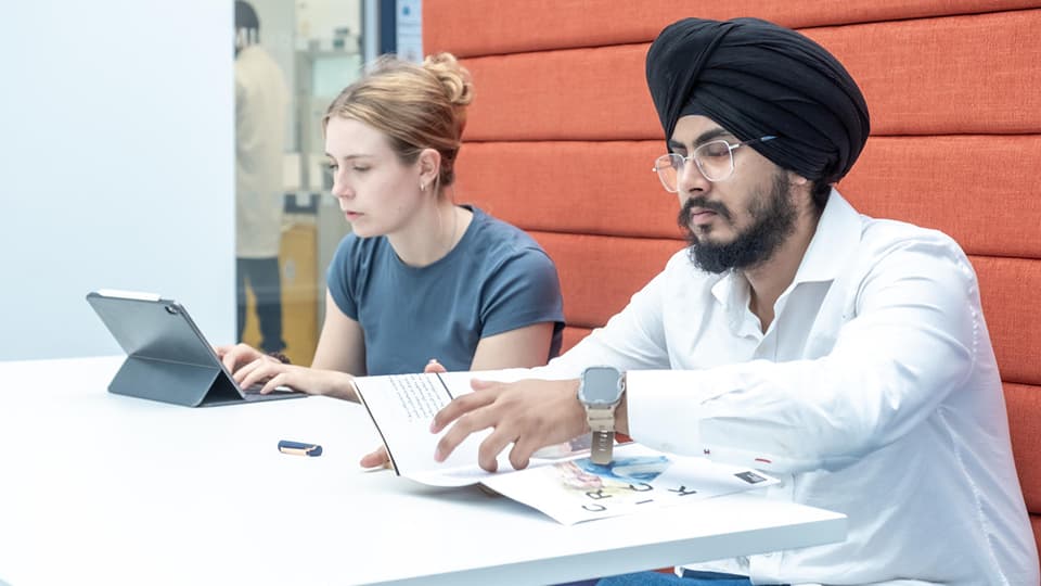 Two students working independently at a desk