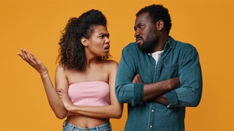 A couple arguing with an orange background