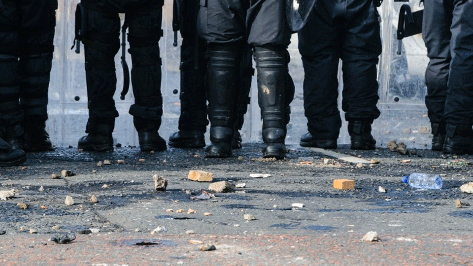 The lower bodies of a group of riot police