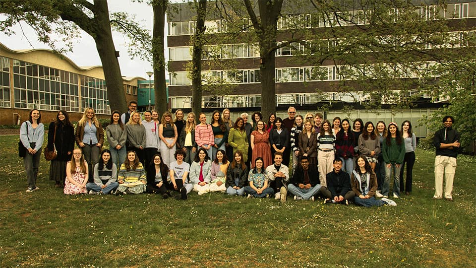 English students and staff stanfing outside