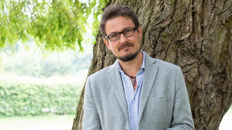 Kerry stood in front of a tree