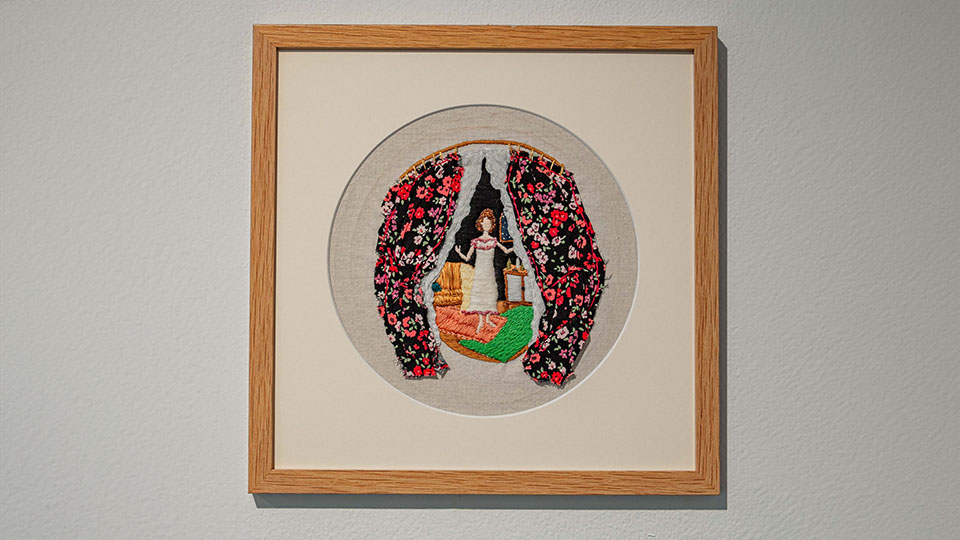 A cross-stitch of a woman framed by curtains