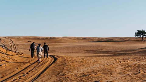 people walking along a track in Namibia
