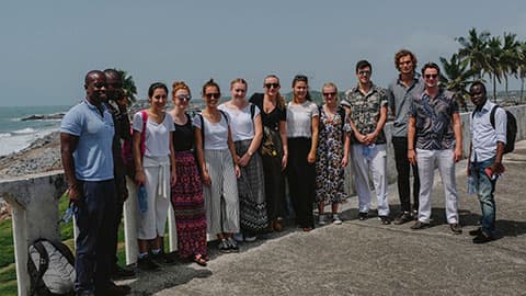 a group of people standing by the sea