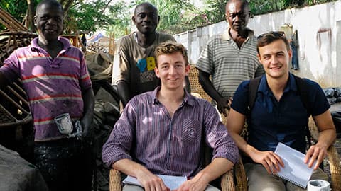 two people seated, three standing