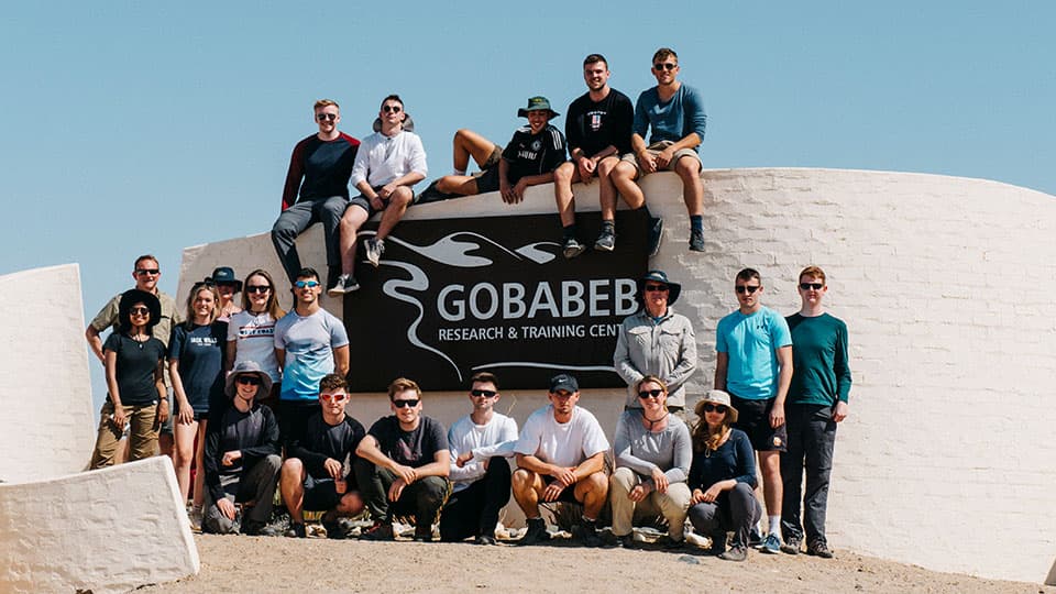 a large group of people pose for a photograph in Namibia