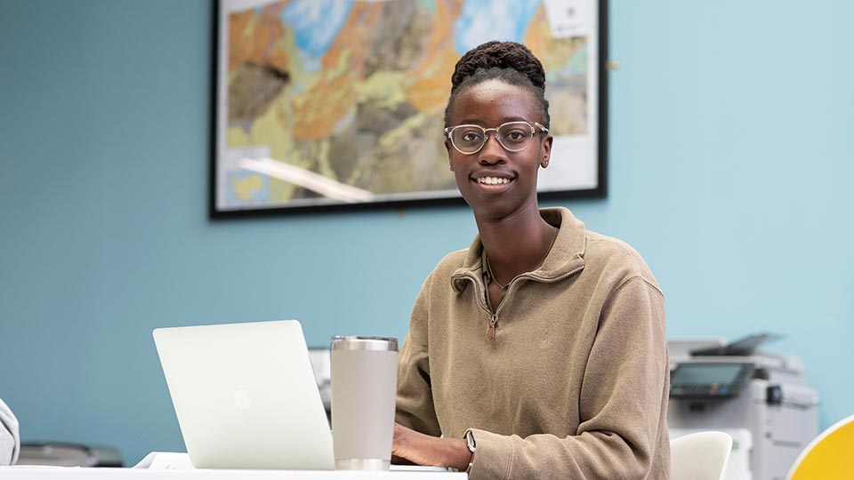 Bosi sat working on a laptop