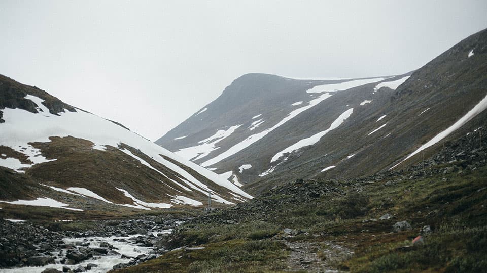 a landscape in winter leading to snowy mountains in Sweden