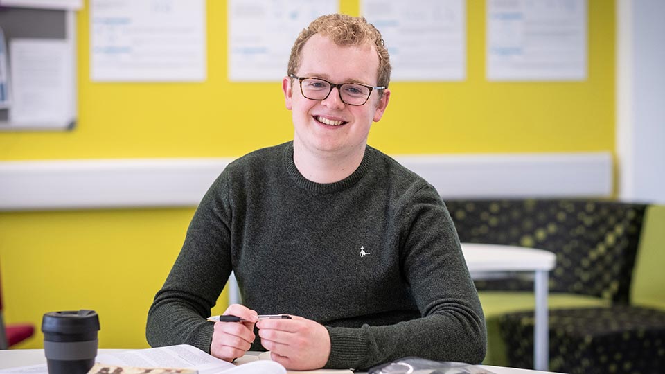 Josh sat smiling at the camera