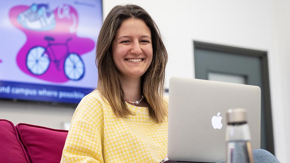 Nicki sat at a desk with a laptop