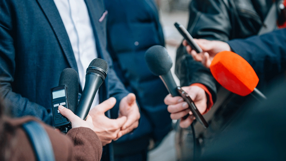 microphones being held for a politician to speak