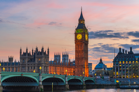 Sunset over the thames river, big ben, and westminster bridge in London.