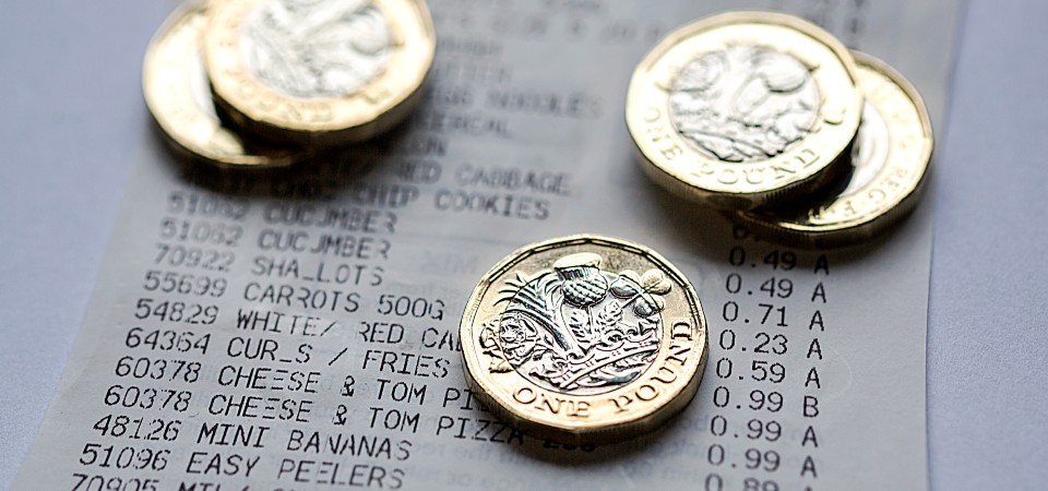 Pound coins on top of a receipt