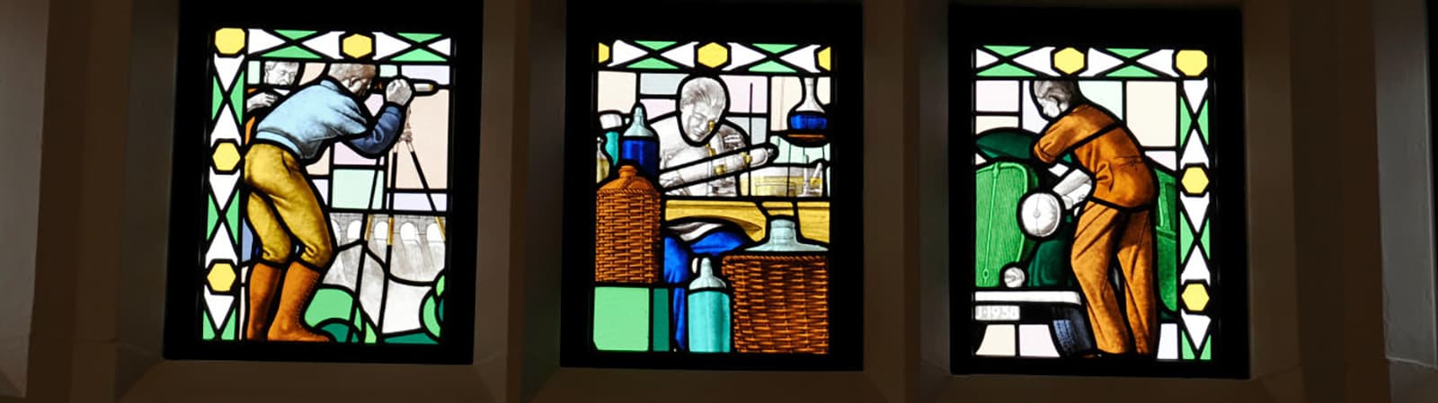 Stained glass in Hazlerigg depicting students at work in the time of the engineering college.