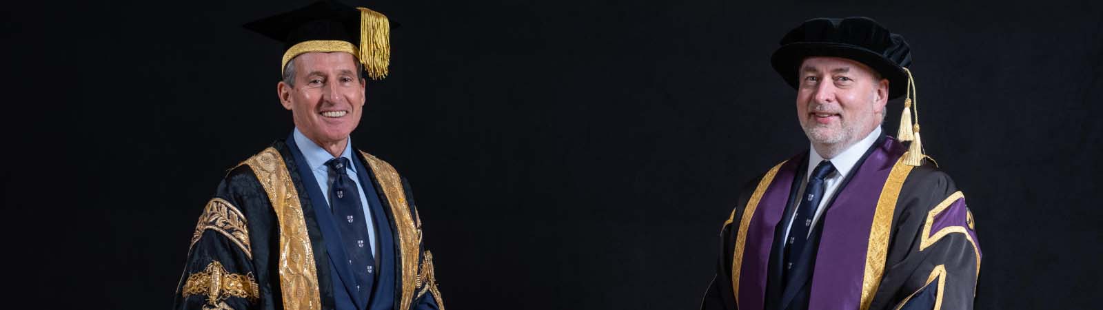The Chancellor (Lord Coe) and the Vice-Chancellor (Prof Jennings) in robes against a black background.