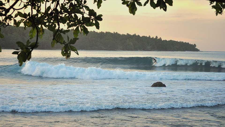 Beach on a tropical island with high tide at sunrise