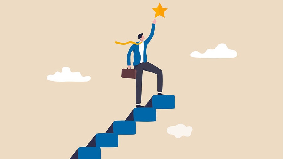 Businessman climbing up stairs, determined to reach the top of a ladder, symbolizing ambition and career advancement.