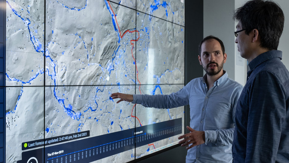 Previsico co-founders, Dr Avi Baruch and Professor Dapeng Yu, reviewing a flood data map