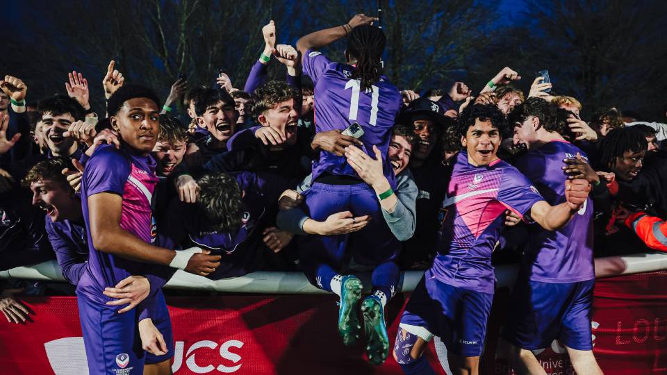 football players celebrate with the crowd