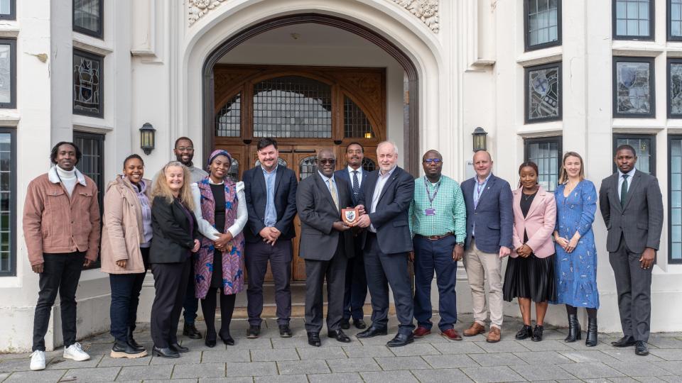 Vice Chancellor and colleagues stood with the High Commissioner of Kenya and his delegation in front of the Hazlerigg Building entrance outside