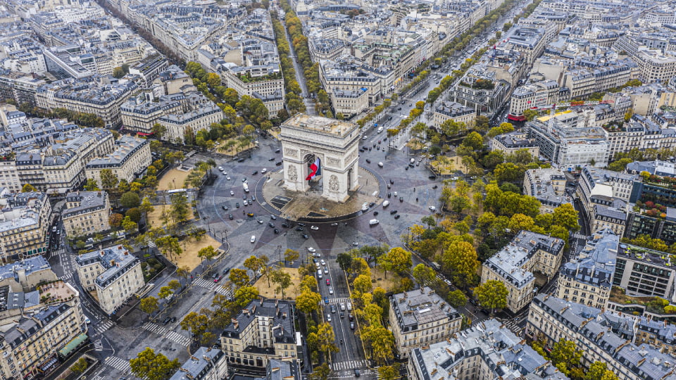 an aerial photograph of the arc de triomphe in Paris