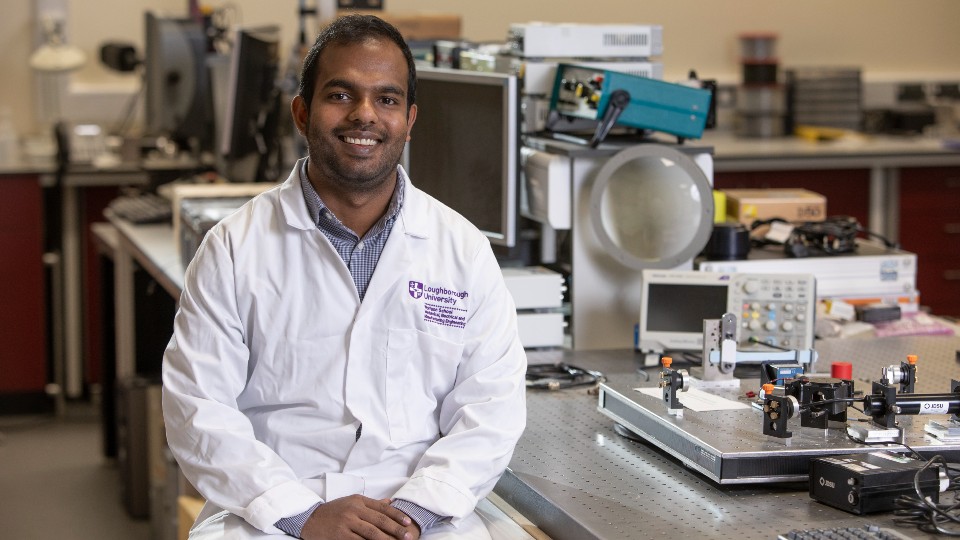 Dr Ishara Dharmasena sitting in a laboratory