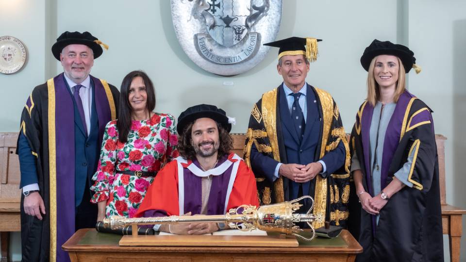 Joe Wicks collects his university honorary degree from the University leadership team