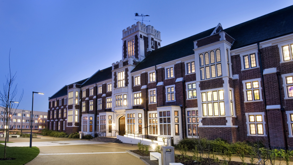 Hazelrigg building on campus at dusk