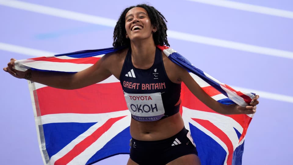 athlete Didi bronze stood with a Great Britain flag around her shoulders