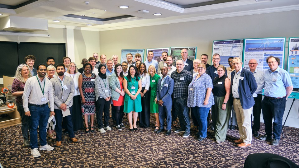 A group of people at the conference smiling for a photograph.
