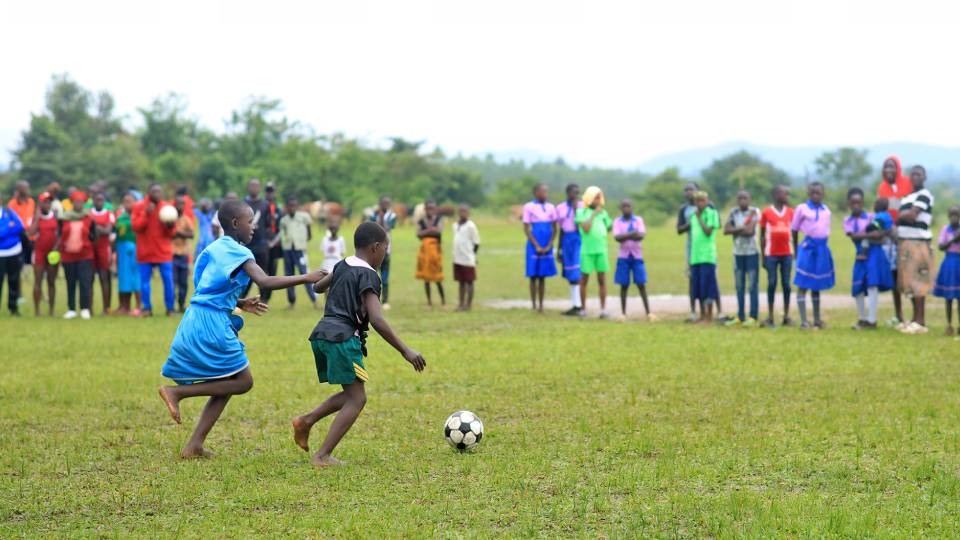 children playing football in africa