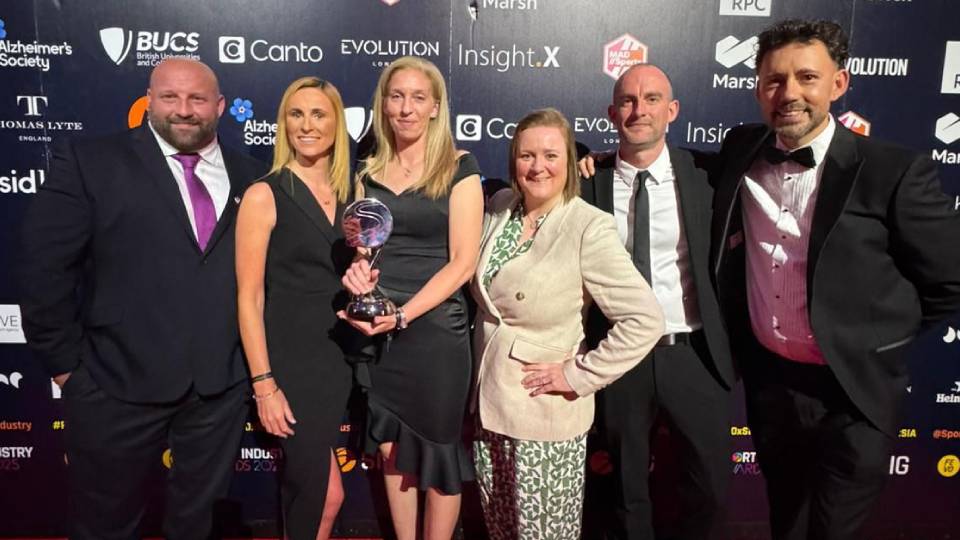 Loughborough staff pose with the sports industry award