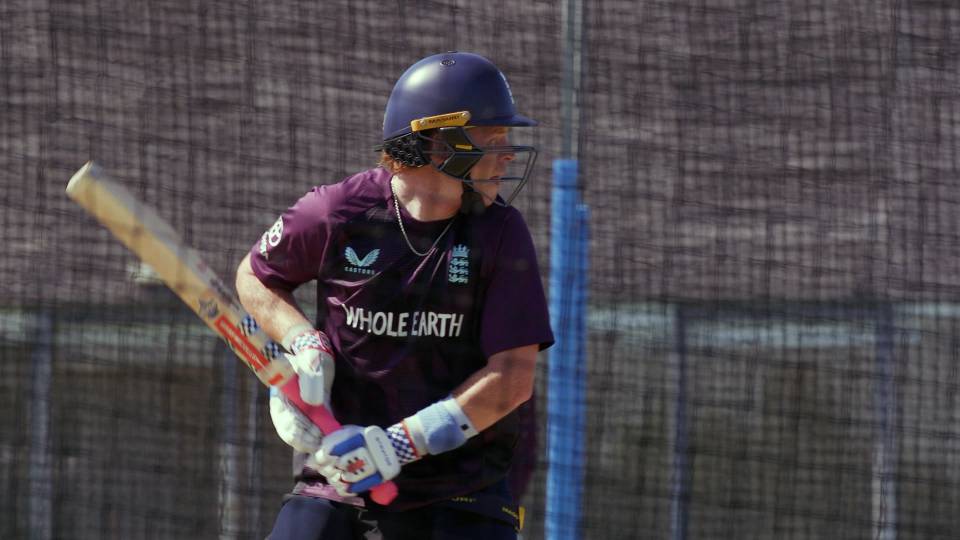 a cricketer prepares to take a shot