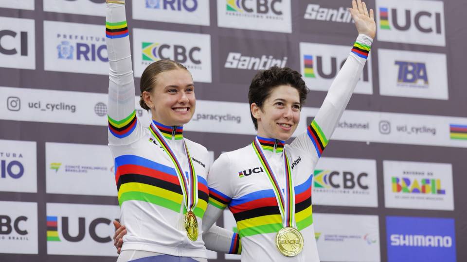 two athletes on a podium with medals