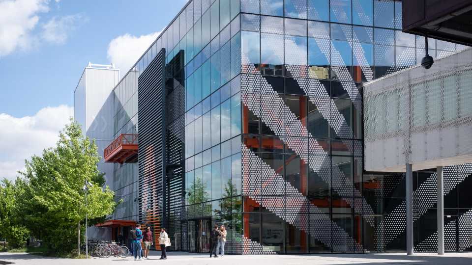 A group of students gathered at the entrance of the Loughborough University London building.