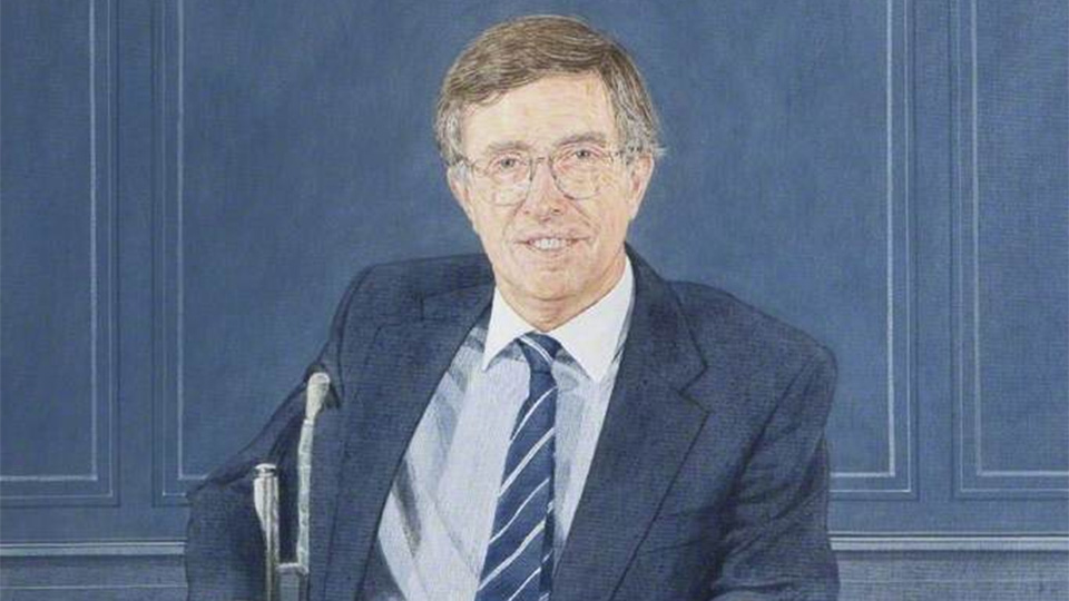 A portrait of Sir David Davies, seated agaist a blue background