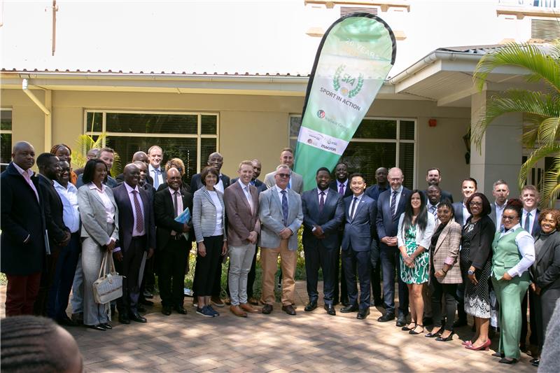 A group of people stood outside of a building in Zambia.