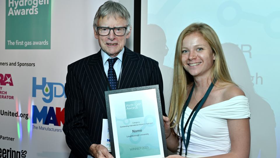 Dr Lizzie Ashton, Senior Research Associate from the Battery-Electrolyser Team, collects the Outstanding International Impact for Hydrogen Award from Professor Kevin Kendal at the Hydrogen Awards