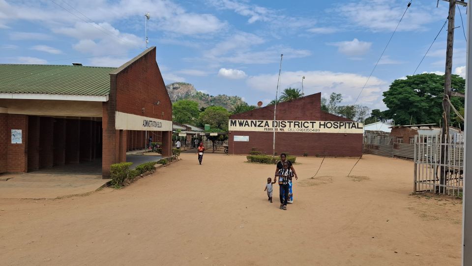 People walking outside of Mwanza District Hospital in Malawi.