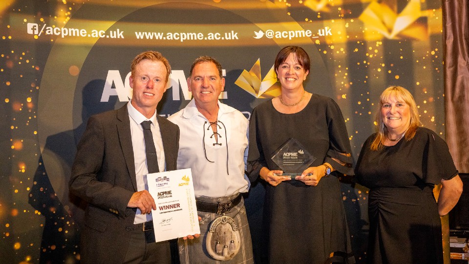 The Brand Digital and Creative Production Team posing for a photo with a certificate and the awards presentation evening.