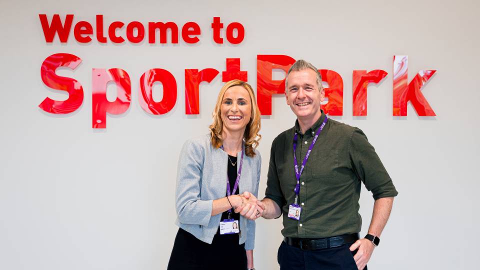 a posed shot of two people shaking hands