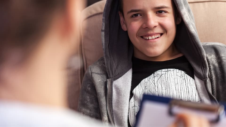 A child sat talking to an adult
