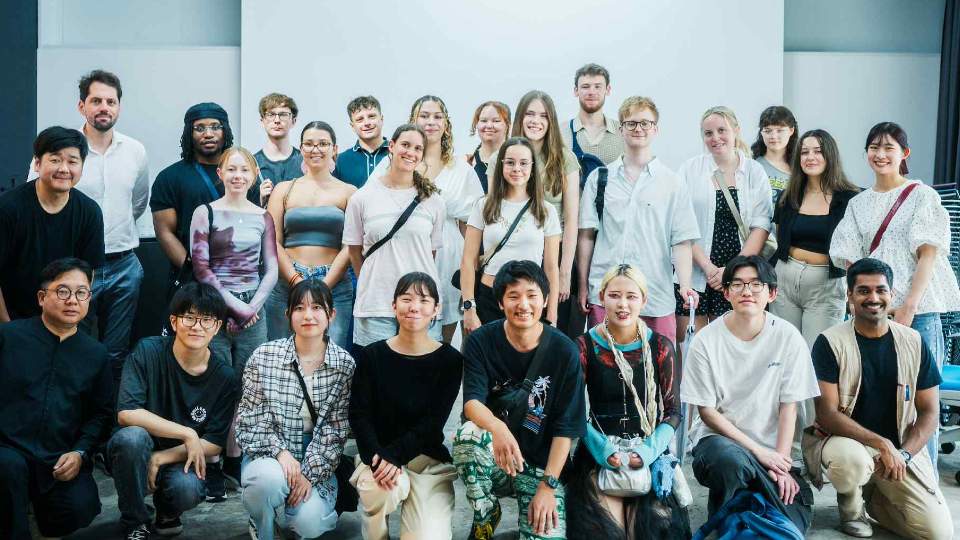 Architecture students stood together smiling at the camera.